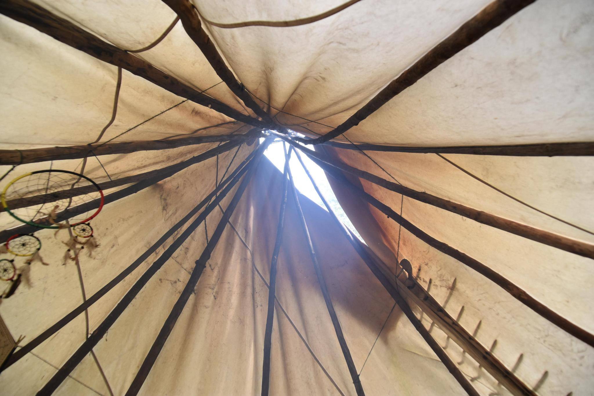 Looking upward through the traditional tipi at Rawaland